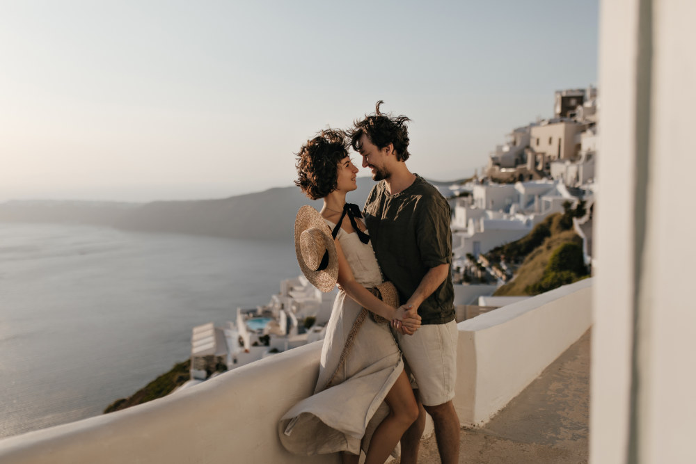 Romantic couple on background of Santorini Caldera